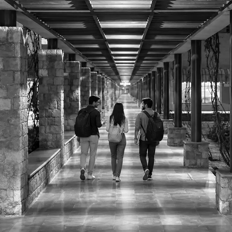 Students walking through the ISB campus colonnade